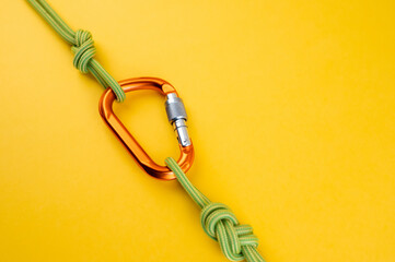 Orange Carabiner with rope. Equipment for climbing and mountaineering, alpinism, rappelling. Safety...