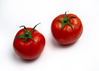 Two red tomatoes on white background