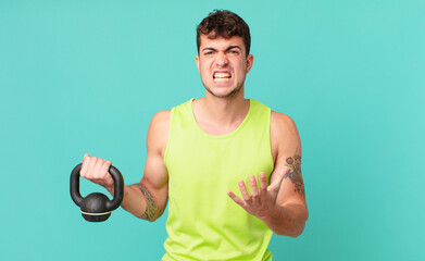 fitness man looking angry, annoyed and frustrated screaming wtf or what’s wrong with you