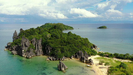 Tropical island with a white beach and limestone cliffs, aerial view. Sabitang Laya, Caramoan...