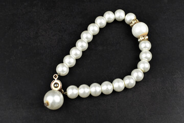 pearl necklace on black background