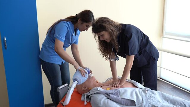 Nursing students are learning how to rescue the patients in emergency. CPR training with CPR doll.