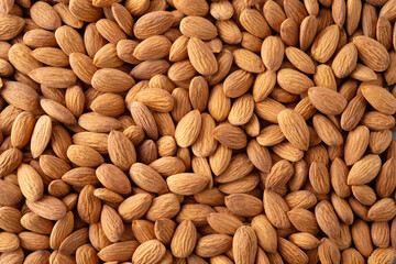 Almond background. Almonds top view background. Whole almond nuts flat lay. Full depth of field.