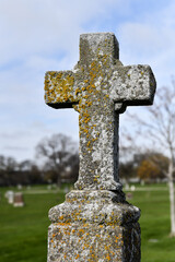 Weathered old vintage cemetery tomb and gravestone with moss