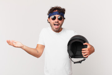 motorbike rider feeling happy, excited, surprised or shocked, smiling and astonished at something...