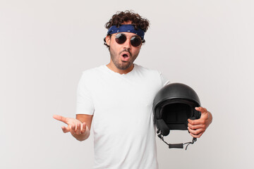 motorbike rider open-mouthed and amazed, shocked and astonished with an unbelievable surprise
