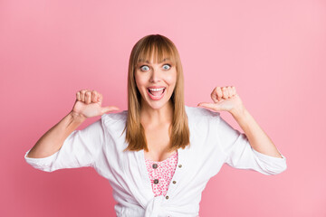 Photo of young cheerful attractive woman happy positive indicate thumb herself proud victory isolated over pink color background