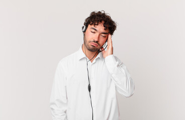 telemarketer feeling bored, frustrated and sleepy after a tiresome, dull and tedious task, holding...