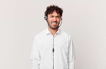 telemarketer feeling disgusted and irritated, sticking tongue out, disliking something nasty and...