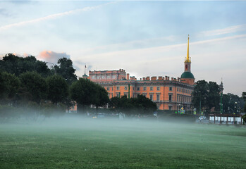 Mikhailovsky Castle and Field of Mars in an early foggy morning in St. Petersburg.
