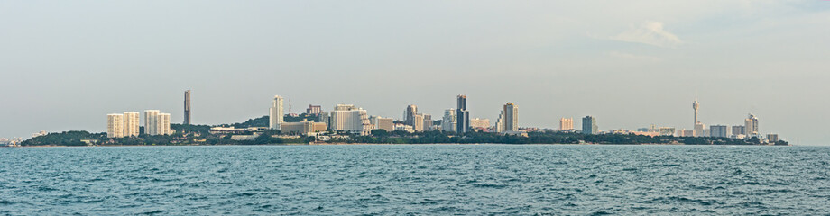 view from water of a Thailand city and the blue sea with sunlight