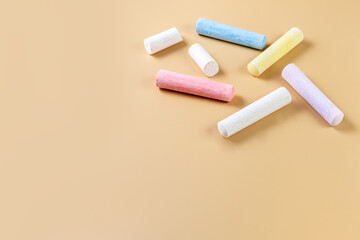 Colored crayons on a beige background. Child Game. Hobby. Child development and leisure concept. Copy space.