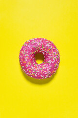 Creative food diet concept photo of donut bite on yellow background.