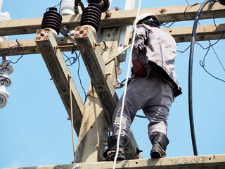 electrician man working at height and dangerous ,high voltage power line maintenance