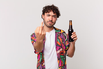 hispanic man with beer feeling angry, annoyed, rebellious and aggressive, flipping the middle...