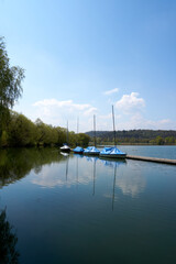 blue and white boats on the beautiful Max-Eyth-See lake under blue sky in sunshine