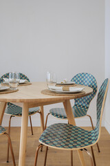 Details of a classic interior with wooden dining area. Scandinavian style of the apartment in warm colors with copy space