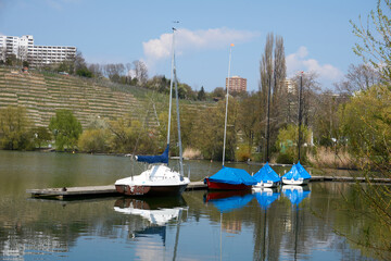 blue and white boats on the beautiful Max-Eyth-See lake under blue sky in sunshine