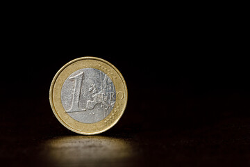one euro coin on black background