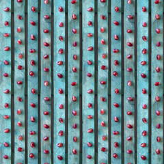 Seamless textured background. Red pomegranate seeds on a turquoise board. 4 fragments in one.