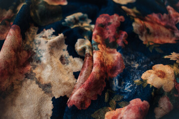 velvet fabric with a print of colored flowers close up 