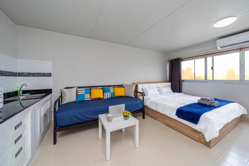 Luxury Interior living room, sofa bed, queen size bed, work space working with technology laptop, Studio room type of condominium or apartment, service apartment and Accommodations Concept