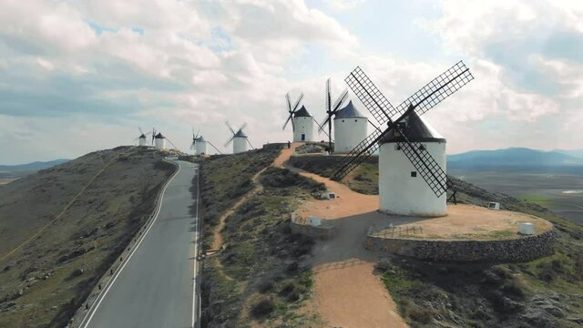 Drone point of view famous windmills in Consuegra town, symbol of Castilla-La Mancha, some windmills still work since their manufacture. History and heritage in Toledo concept. Europe, Toledo. Spain
