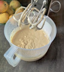  Pancake batter. Knead the batter with a mixer. Kitchen background.
