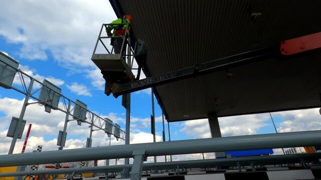 Voronezh, Russia - April 22, 2021. The worker rises to perform the installation at a height of.