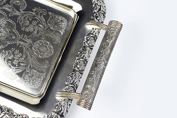 Antique silver tray with handles. Old luxury tray isolated on white background with copy space. Closeup