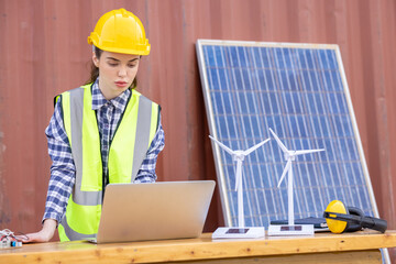  american women engineer and caucasian electrician wearing yellow  hard hat working on laptop computer