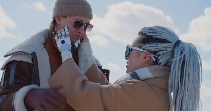 The woman with the bionic prosthesis and her boyfriend are cuddling on a frozen Baikal lake Bionics Cybernetic Robotic-arm Hand prosthesis Baikal