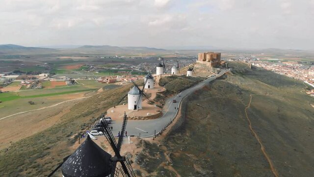 Drone point of view famous windmills in Consuegra town, symbol of Castilla-La Mancha, some windmills still work since their manufacture. History and heritage in Toledo concept. Europe, Toledo. Spain
