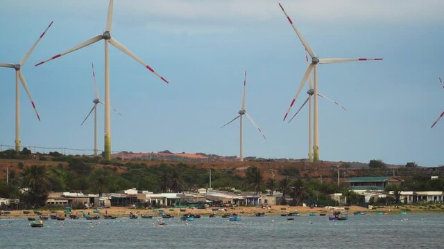 Wind Turbines Generating Clean Renewable Energy By The Beach In Son Hai, Vietnam. wide shot