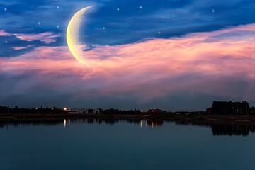 Crescent moon with beautiful sunset background . bright sky © yaalan