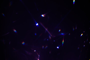 Blur colorful warm rainbow crystal light leaks on black background. Defocused abstract retro film...