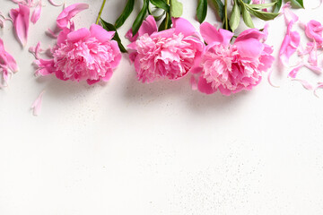 Bouquet of beautiful pink peony flowers on white background. Copy space. View from above. Festive greeting card with peony for weddings, happy women's day and Mothers day.