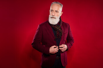 Photo portrait of senior man wearing vintage outfit looking copyspace isolated on bright red color background