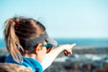 Woman pointing to the horizon