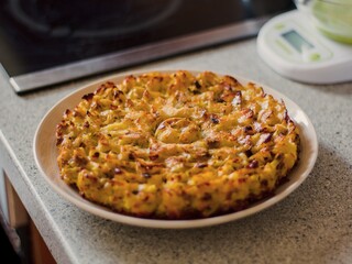 homemade baked bulgarian patatnik potato pie on a white plate in the kitchen