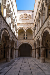 Stone arches decorate the Sponza palace inside the old town of Dubrovnik Croatia