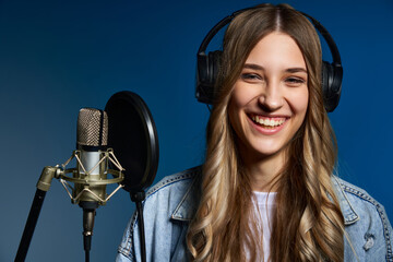 Girl blogger recording audio podcast.