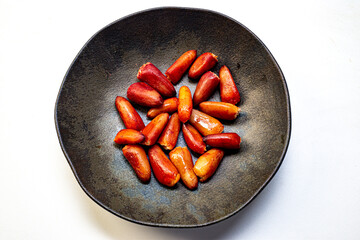 Pine nuts cooked inside a rustic ceramic dish. Typical winter food in southern Brazil. They are the seeds of the fruit of an Araucaria and widely used in Brazilian gastronomy.