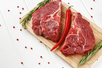 Beef tenderloin on wooden board on wooden table
