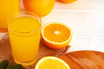 Close up of orange juice glass on wooden table