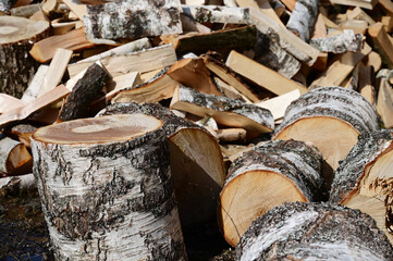 Stocks of birch logs close-up. Harvesting firewood for the winter. Background of firewood