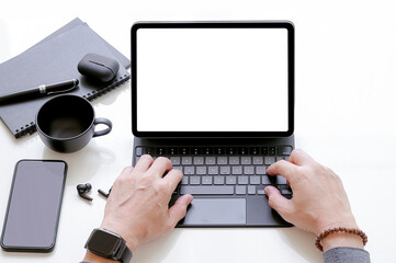 Closeup view of man hand working on tablet with keyboard.