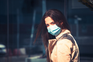 Girl with medical mask is staying in the city during pandemic of Coronavirus Covid-19