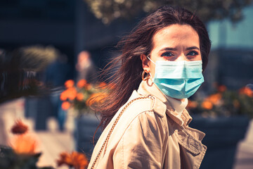 Girl with medical mask is staying in the city during pandemic of Coronavirus Covid-19