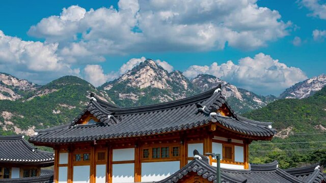 Eunpyeong hanok village and have bukhansan mountain the back with blue sky and white clouds in seoul city south korea(zoom out)